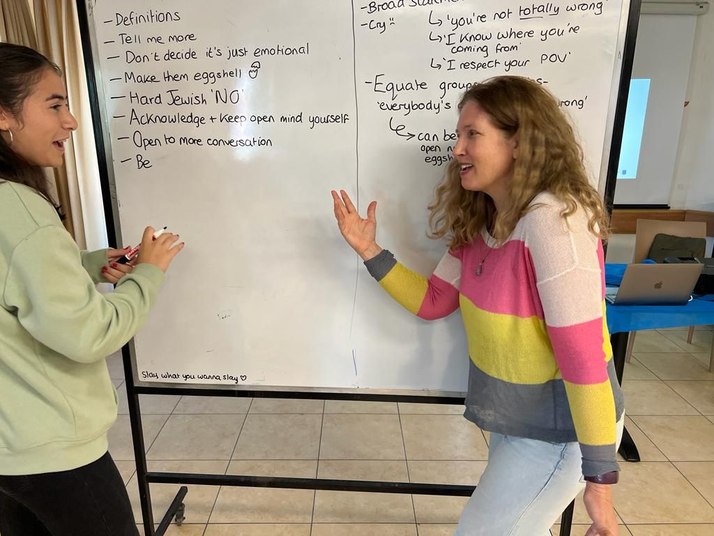 Amy Weinreb teaching a student in front of a whiteboard